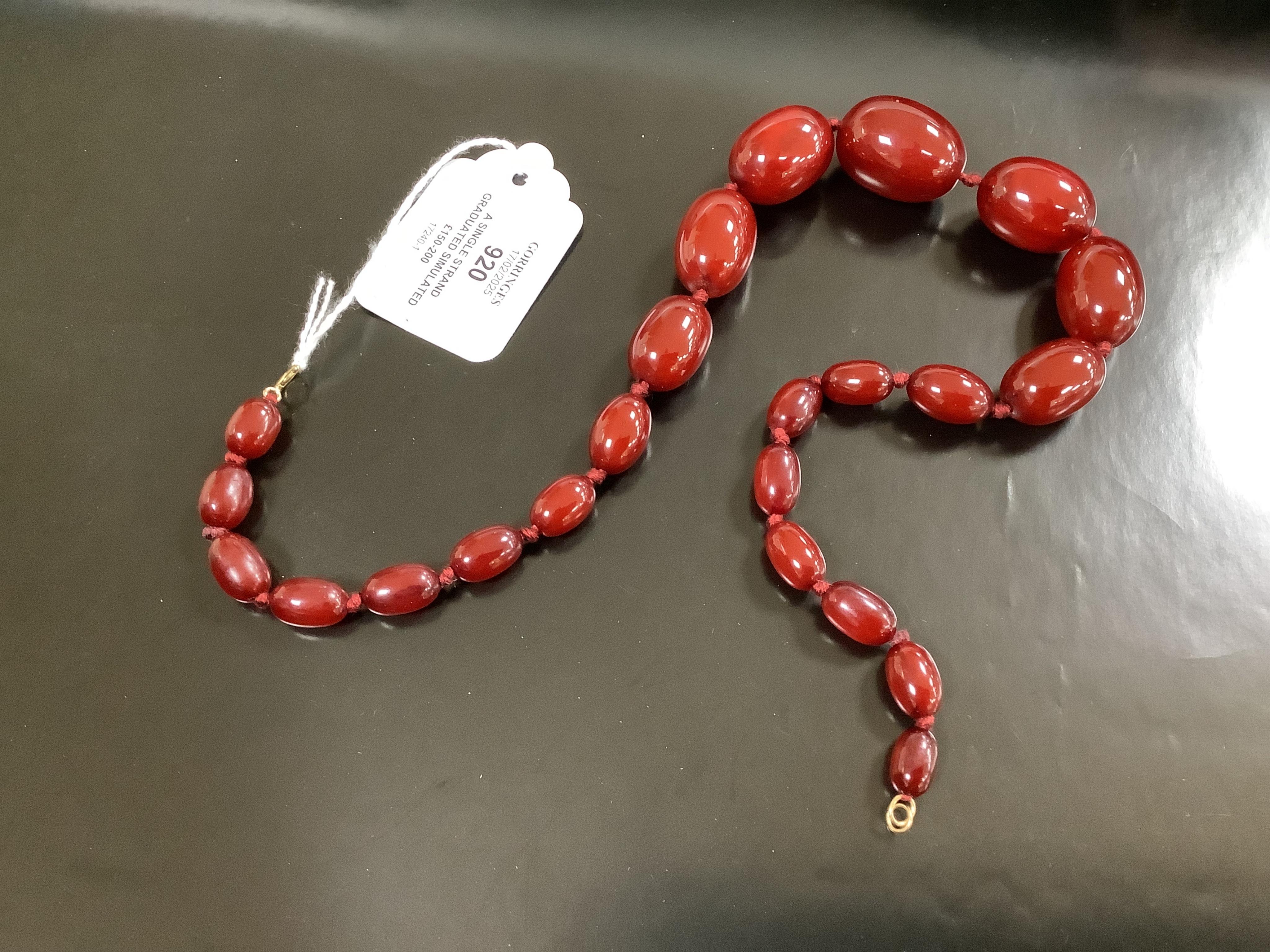 A single strand graduated simulated cherry amber necklace, 46cm, gross weight 58 grams. Condition - fair to good